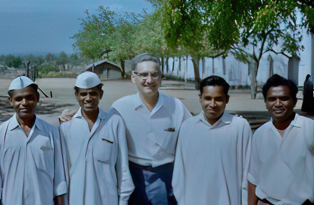 Roy with a team of evangelists with the mission station church in the background.