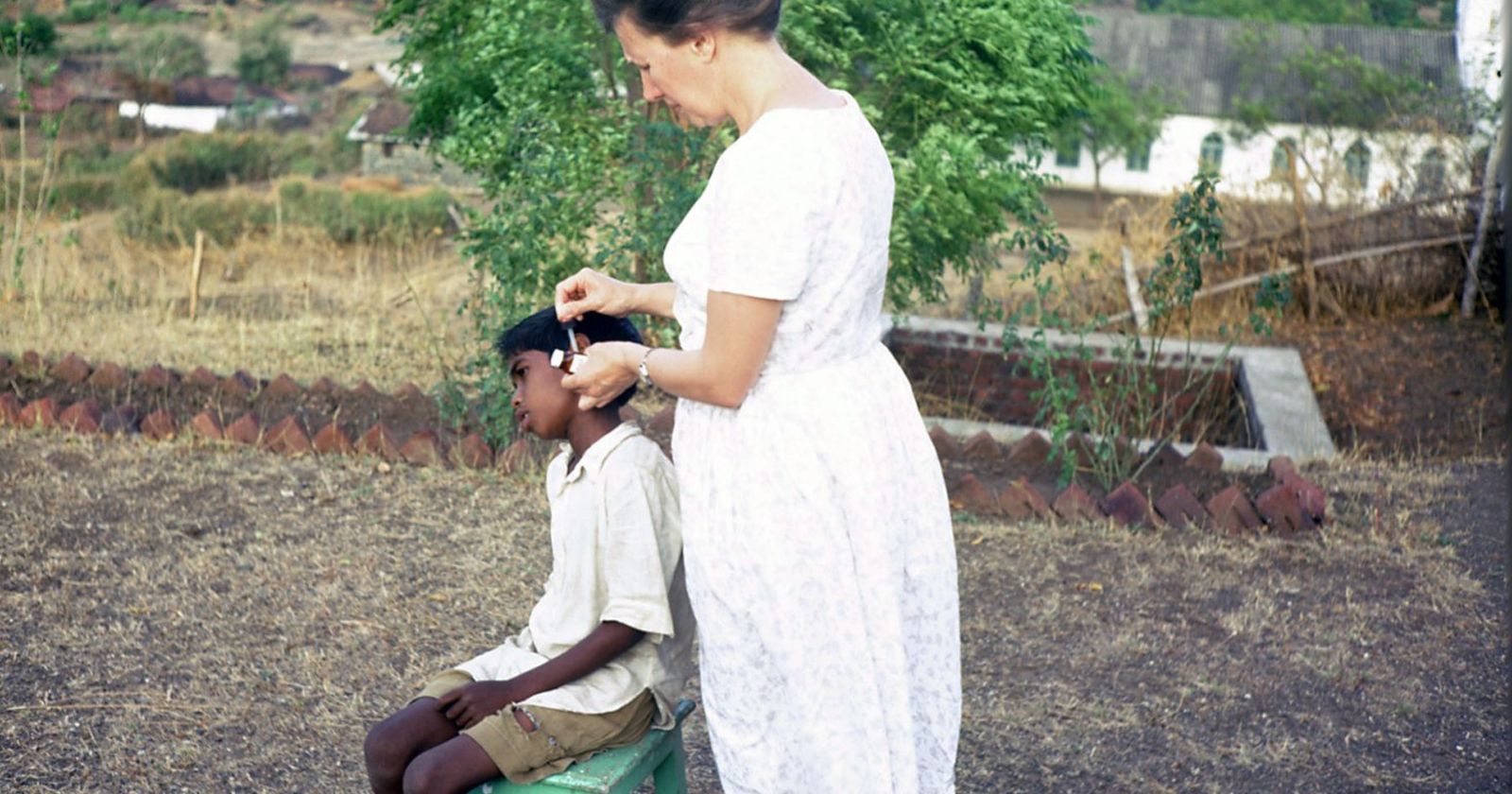 Adelina treating one of the boarding boys during clinic hours. She had received some nursing training before India.