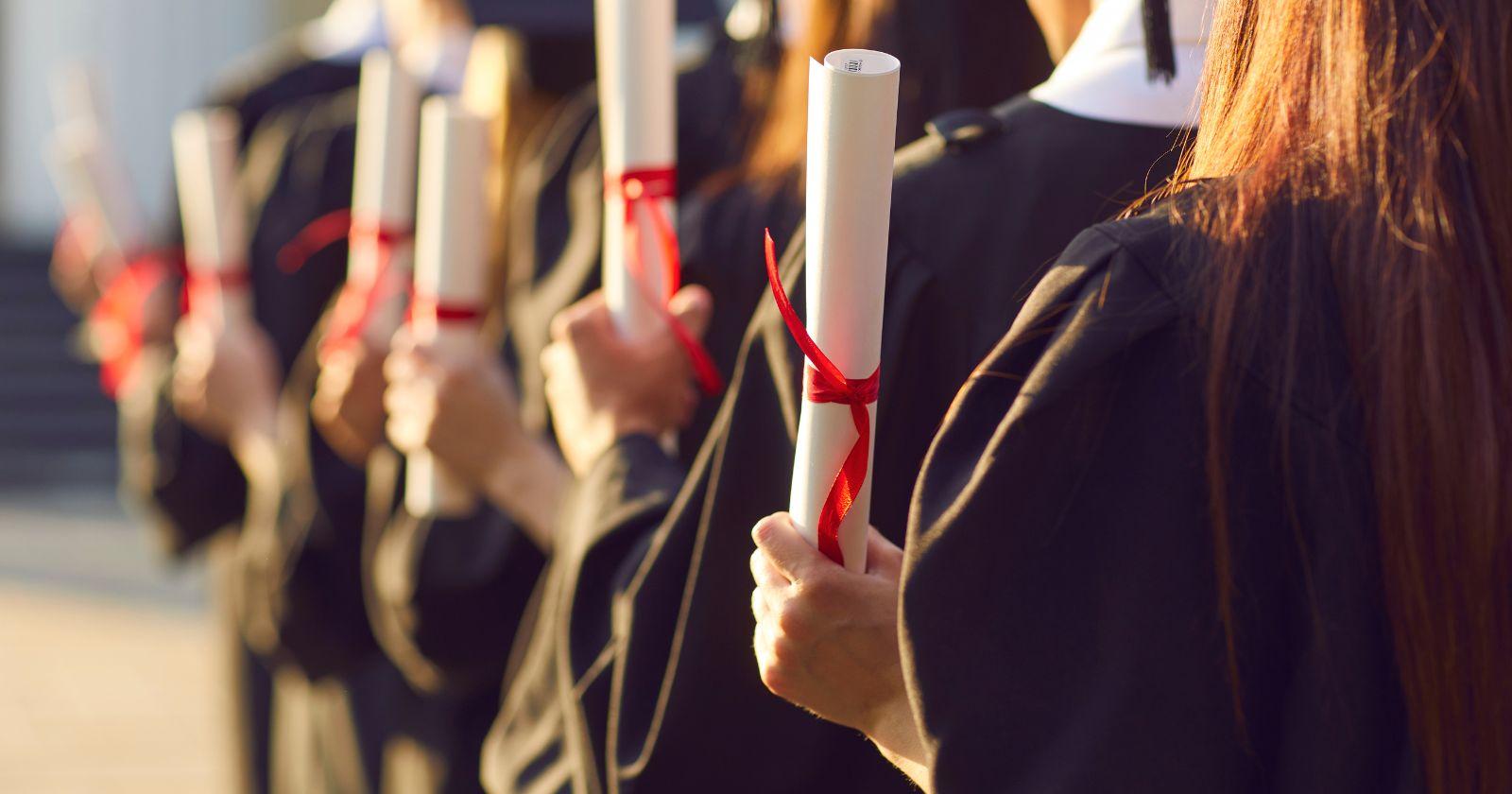 graduating students with their diplomas